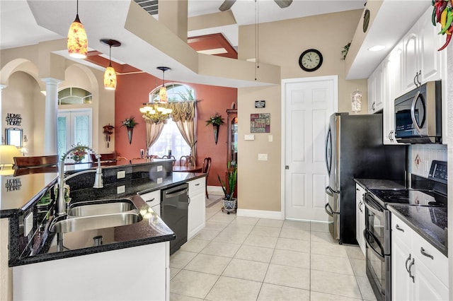2801 SW 29th Ct, Cape Coral, FL 33914 - kitchen featuring stainless steel appliances, decorative columns, white cabinets, light tile patterned floors, and a towering ceiling