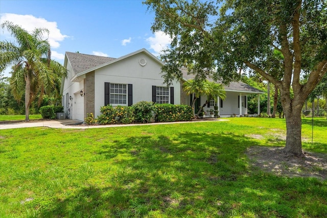 21705 67th Ave E, Bradenton, FL 34211 - view of front of property featuring an attached garage, concrete driveway, a front yard, covered porch, and stucco siding