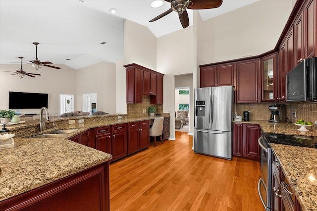 21705 67th Ave E, Bradenton, FL 34211 - kitchen with appliances with stainless steel finishes, ceiling fan, dark brown cabinets, open floor plan, and high vaulted ceiling