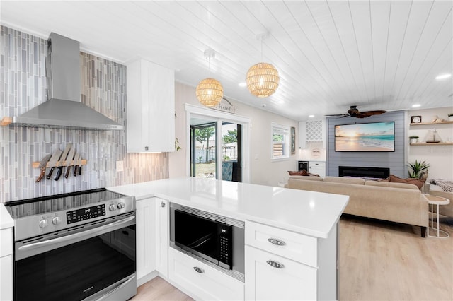 327 Francis Dr, Apollo Beach, FL 33572 - kitchen featuring appliances with stainless steel finishes, wall chimney exhaust hood, a peninsula, light countertops, and wood ceiling