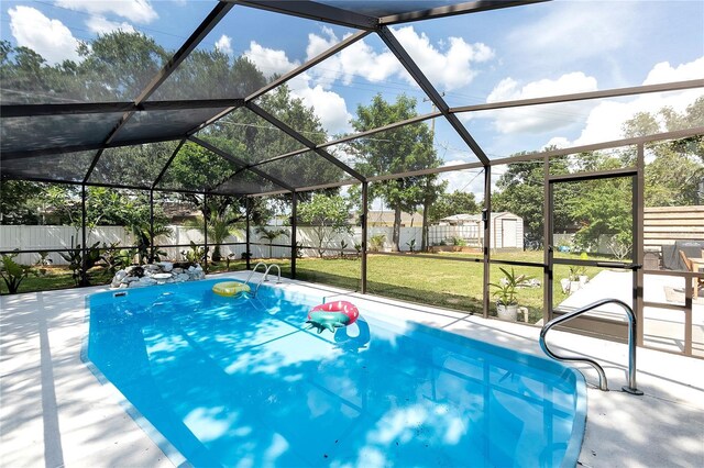 327 Francis Dr, Apollo Beach, FL 33572 - view of swimming pool with a storage unit, a fenced backyard, a patio area, and a lanai