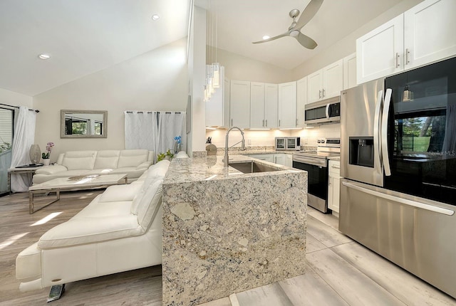 718 White Pine Tree Rd Unit 80, Venice, FL 34285 - kitchen featuring appliances with stainless steel finishes, white cabinets, ceiling fan, light stone countertops, and light wood-style floors