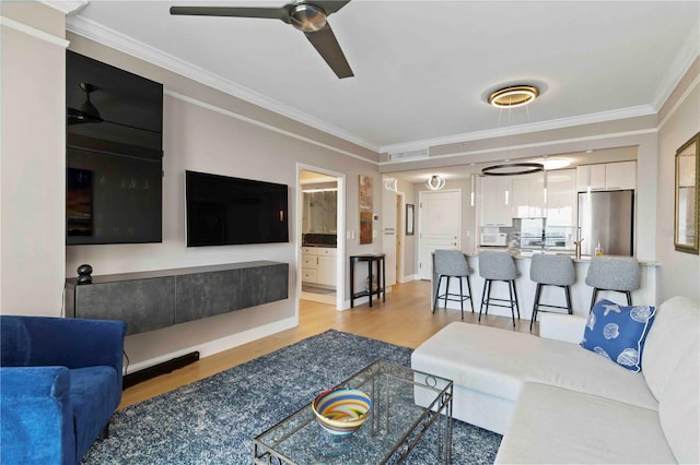 750 N Tamiami Trl Unit 1005, Sarasota, FL 34236 - living area with light wood-type flooring, ornamental molding, and a ceiling fan