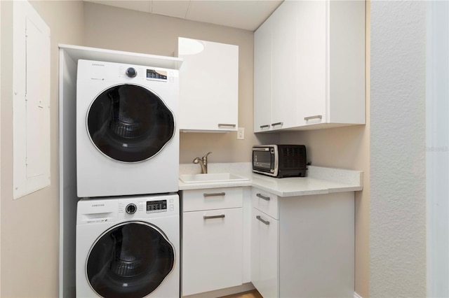 750 N Tamiami Trl Unit 1005, Sarasota, FL 34236 - laundry area featuring stacked washer / drying machine and a sink