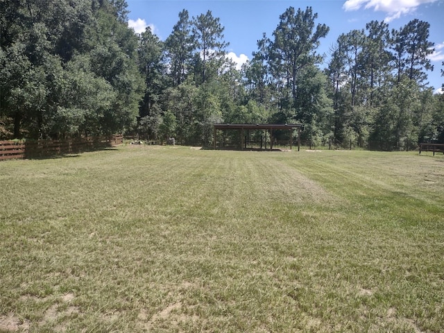 8851 S Brittany Path, Inverness, FL 34452 - view of green lawn with a detached carport