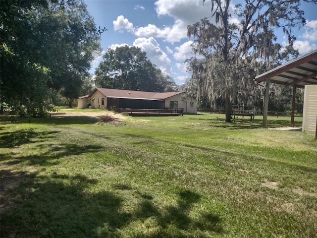 8851 S Brittany Path, Inverness, FL 34452 - view of grassy yard with a wooden deck