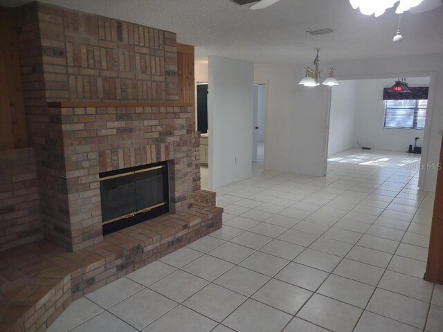 8851 S Brittany Path, Inverness, FL 34452 - unfurnished living room with light tile patterned floors, a brick fireplace, a chandelier, and ceiling fan