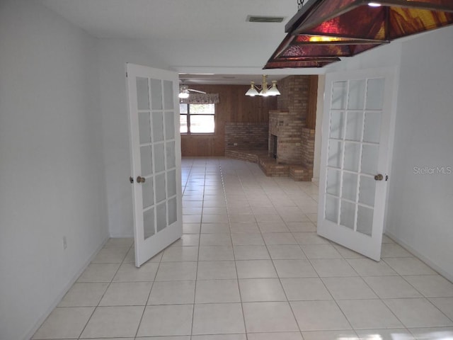 8851 S Brittany Path, Inverness, FL 34452 - corridor with french doors, light tile patterned floors, and wooden walls