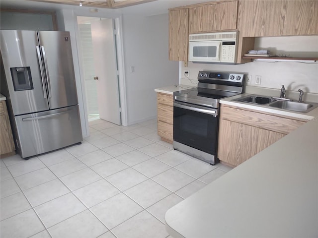 8851 S Brittany Path, Inverness, FL 34452 - kitchen featuring stainless steel appliances, light countertops, light brown cabinetry, and light tile patterned floors
