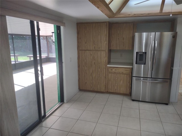 8851 S Brittany Path, Inverness, FL 34452 - kitchen with stainless steel fridge with ice dispenser, plenty of natural light, brown cabinets, and light countertops