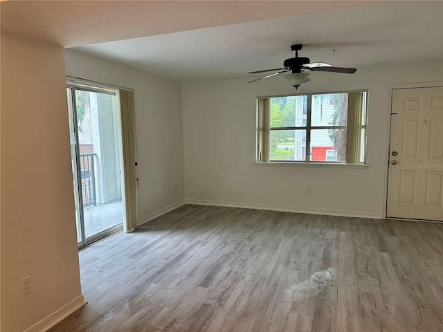 2360 SW Archer Rd Unit 206, Gainesville, FL 32608 - unfurnished living room featuring plenty of natural light, wood finished floors, and ceiling fan