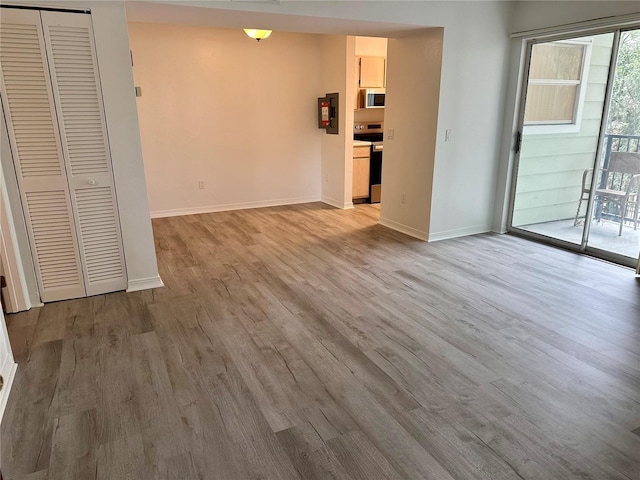 2360 SW Archer Rd Unit 206, Gainesville, FL 32608 - unfurnished living room with light wood-style flooring and baseboards