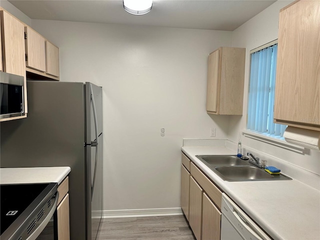 2360 SW Archer Rd Unit 206, Gainesville, FL 32608 - kitchen featuring appliances with stainless steel finishes, light brown cabinets, light wood-style floors, and light countertops