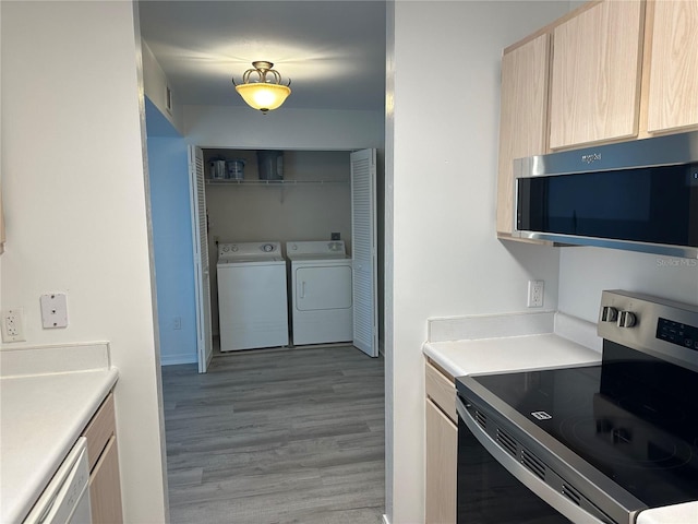 2360 SW Archer Rd Unit 206, Gainesville, FL 32608 - kitchen with appliances with stainless steel finishes, light brown cabinets, separate washer and dryer, light wood-style floors, and light countertops