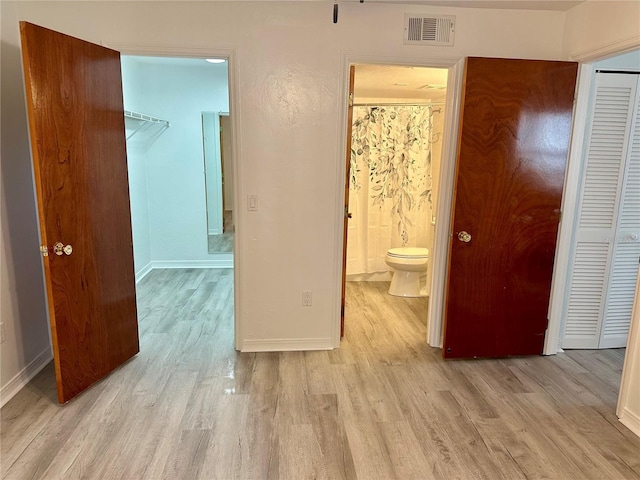2360 SW Archer Rd Unit 206, Gainesville, FL 32608 - bedroom featuring a closet, light wood-type flooring, and a spacious closet