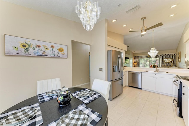 9580 High Gate Dr Unit 1822, Sarasota, FL 34238 - kitchen featuring appliances with stainless steel finishes, a chandelier, light countertops, lofted ceiling, and pendant lighting