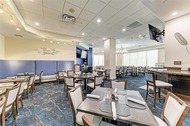 9580 High Gate Dr Unit 1822, Sarasota, FL 34238 - dining room featuring a wainscoted wall and a drop ceiling