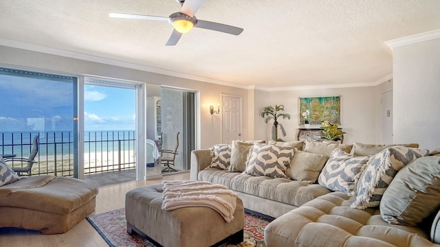 1 Benjamin Franklin Dr Unit 93, Sarasota, FL 34236 - living area featuring wood finished floors, a ceiling fan, a textured ceiling, crown molding, and a water view
