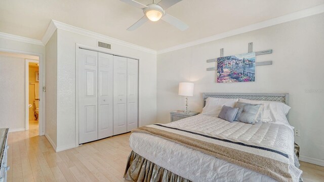 1 Benjamin Franklin Dr Unit 93, Sarasota, FL 34236 - bedroom featuring light wood-style floors, crown molding, a closet, and ceiling fan