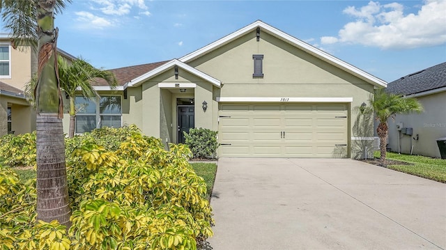 3813 Willow Branch Pl, Palmetto, FL 34221 - view of front of house with stucco siding, driveway, and an attached garage