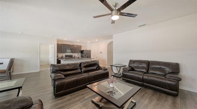 3813 Willow Branch Pl, Palmetto, FL 34221 - living room with ceiling fan, light wood-style floors, arched walkways, and recessed lighting