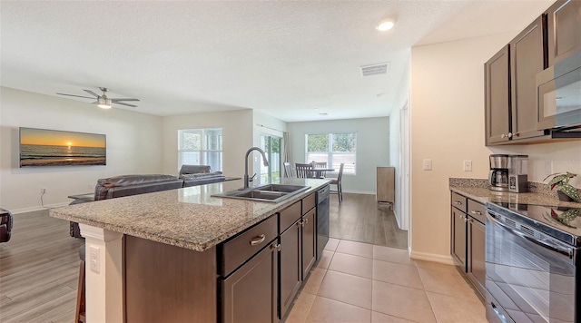 3813 Willow Branch Pl, Palmetto, FL 34221 - kitchen featuring black / electric stove, open floor plan, a kitchen island with sink, ceiling fan, and a textured ceiling