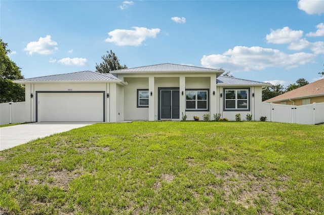 4855 Dragon St, North Port, FL 34288 - view of front facade with an attached garage, a standing seam roof, driveway, a metal roof, and stucco siding
