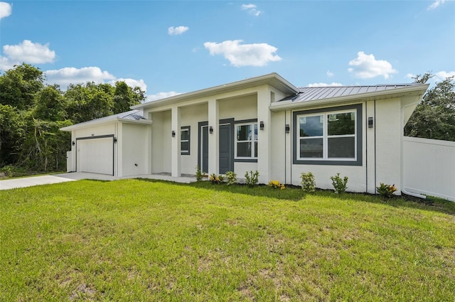 4855 Dragon St, North Port, FL 34288 - view of front of home with a standing seam roof, a garage, concrete driveway, a metal roof, and stucco siding