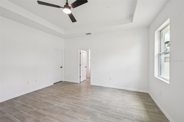 4855 Dragon St, North Port, FL 34288 - spare room featuring a raised ceiling, ceiling fan, and light wood-style flooring