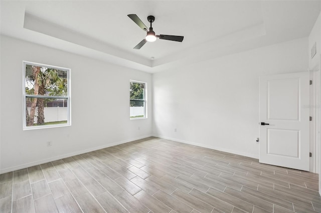 4855 Dragon St, North Port, FL 34288 - spare room with a raised ceiling, ceiling fan, and light wood-type flooring