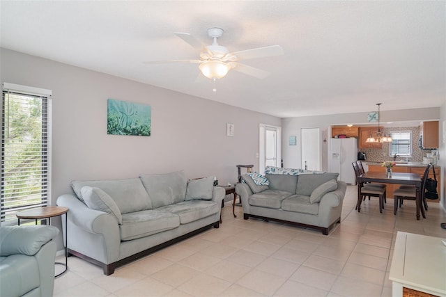 5400 34th St W Unit 5G, Bradenton, FL 34210 - living room featuring a chandelier, a ceiling fan, and light tile patterned floors