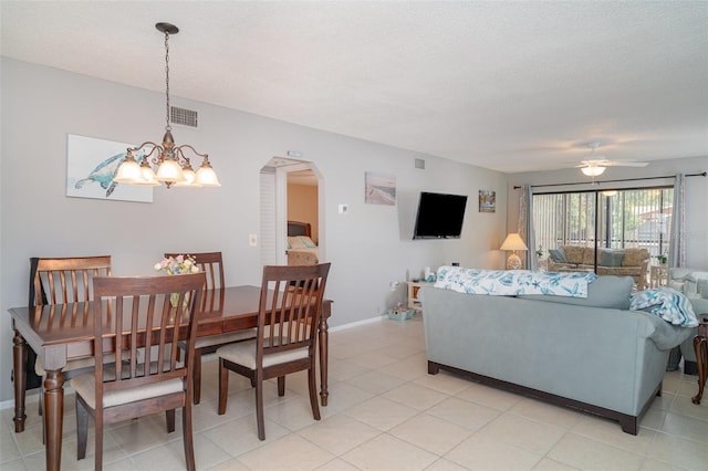 5400 34th St W Unit 5G, Bradenton, FL 34210 - dining room featuring ceiling fan, arched walkways, a chandelier, a textured ceiling, and light tile patterned floors