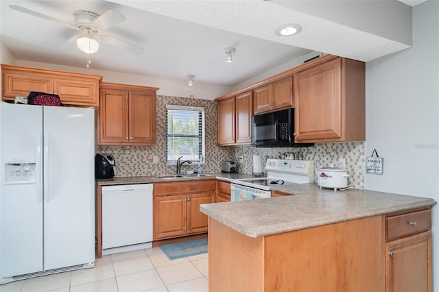 5400 34th St W Unit 5G, Bradenton, FL 34210 - kitchen featuring white appliances, backsplash, a peninsula, light tile patterned flooring, and ceiling fan