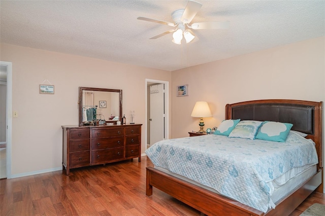 5400 34th St W Unit 5G, Bradenton, FL 34210 - bedroom with wood finished floors, ceiling fan, and a textured ceiling