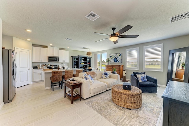 7160 Amelia River Dr, Parrish, FL 34219 - living room featuring ceiling fan, recessed lighting, and a textured ceiling