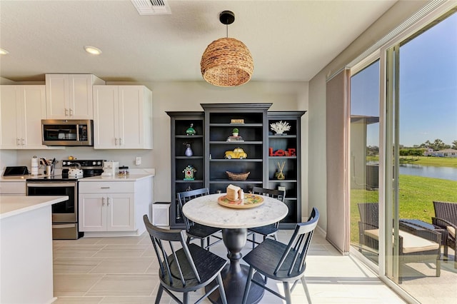 7160 Amelia River Dr, Parrish, FL 34219 - kitchen with appliances with stainless steel finishes, plenty of natural light, light countertops, white cabinetry, and recessed lighting