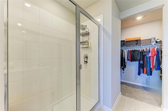 7160 Amelia River Dr, Parrish, FL 34219 - bathroom featuring a stall shower, a spacious closet, and tile patterned flooring