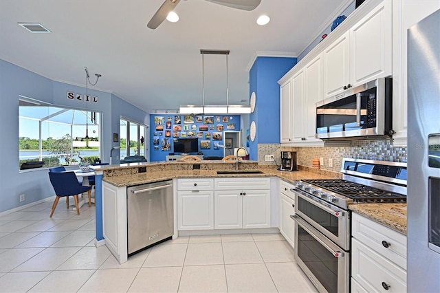 10571 Old Grove Cir, Bradenton, FL 34212 - kitchen featuring stainless steel appliances, a peninsula, backsplash, a ceiling fan, and light tile patterned floors