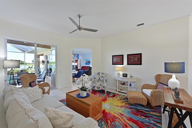 10571 Old Grove Cir, Bradenton, FL 34212 - living area with arched walkways, ceiling fan, and light tile patterned flooring
