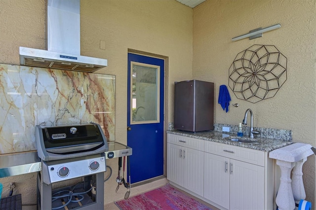 10571 Old Grove Cir, Bradenton, FL 34212 - kitchen featuring wall chimney exhaust hood, light stone countertops, white cabinets, and a textured wall