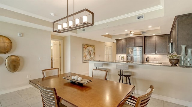 250 Hidden Bay Dr Unit 302, Osprey, FL 34229 - dining room featuring light marble finish flooring, crown molding, a tray ceiling, and recessed lighting