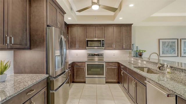 250 Hidden Bay Dr Unit 302, Osprey, FL 34229 - kitchen featuring appliances with stainless steel finishes, a tray ceiling, light marble finish floors, light stone counters, and crown molding