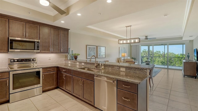 250 Hidden Bay Dr Unit 302, Osprey, FL 34229 - kitchen with a tray ceiling, ceiling fan, appliances with stainless steel finishes, ornamental molding, and recessed lighting
