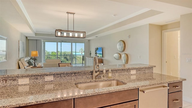 250 Hidden Bay Dr Unit 302, Osprey, FL 34229 - kitchen with a tray ceiling, open floor plan, light stone countertops, dishwasher, and pendant lighting