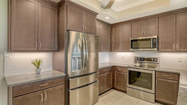 250 Hidden Bay Dr Unit 302, Osprey, FL 34229 - kitchen with appliances with stainless steel finishes, light stone countertops, light marble finish floors, tasteful backsplash, and ornamental molding