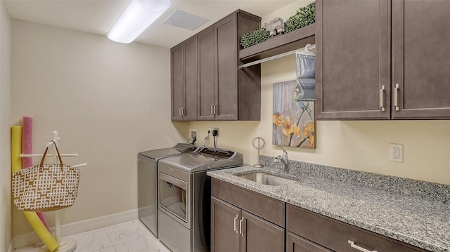 250 Hidden Bay Dr Unit 302, Osprey, FL 34229 - laundry area with washer and dryer, cabinet space, and light marble finish floors