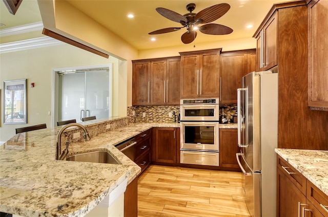 250 Hidden Bay Dr Unit 302, Osprey, FL 34229 - kitchen with a ceiling fan, light wood-style flooring, appliances with stainless steel finishes, light stone counters, and recessed lighting