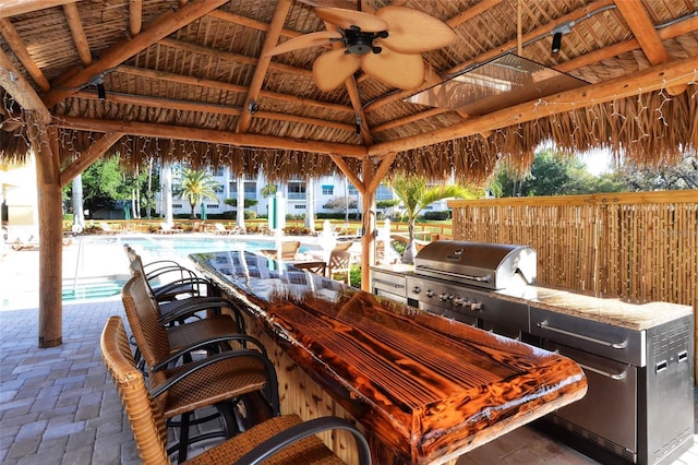 250 Hidden Bay Dr Unit 302, Osprey, FL 34229 - view of patio / terrace featuring a gazebo, a ceiling fan, a community pool, a bar, and area for grilling