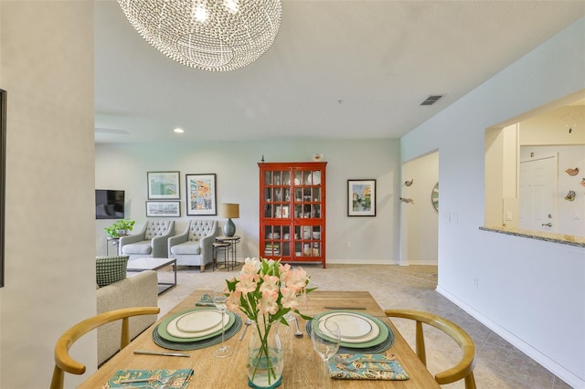 7344 Skybird Rd, Bradenton, FL 34209 - tiled dining area featuring a chandelier and recessed lighting