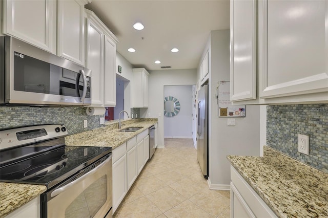 7344 Skybird Rd, Bradenton, FL 34209 - kitchen featuring stainless steel appliances, tasteful backsplash, white cabinets, light tile patterned flooring, and recessed lighting